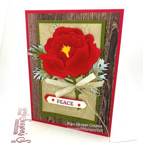 I wanted to create the feel of a Christmas flower using Real Red card stock. I used the Peony Dies and spoonged the interior of each petal which allowed the outside edge to remain lighter. The natural look continues with a wood grain look from the In Good Taste Designer series Paper,Mossy Meadow & Crumb Cake colors. The pine foliage was die cut with the Beautiful Boughs dies and sponged with Frost White Shimmer Paint to mimic snow. Want more Peony Inspiration? See my designated gallery: https://www.pamstrobelcreates.com/prized-peony-stamp-set